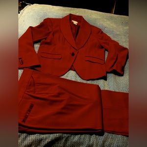 Suit is rich maroon in color